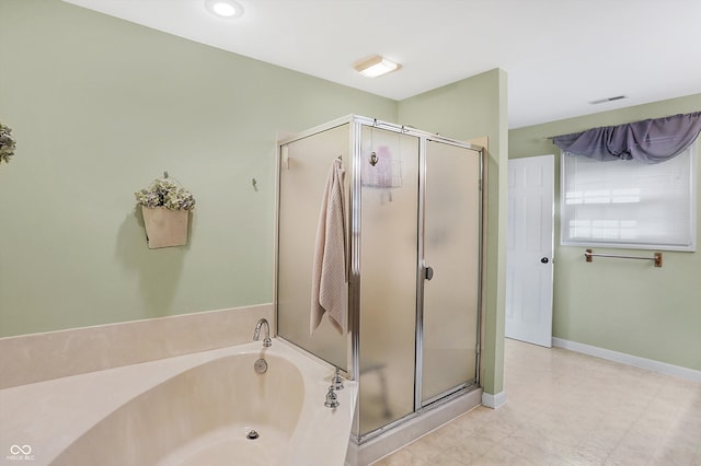 bathroom with shower with separate bathtub