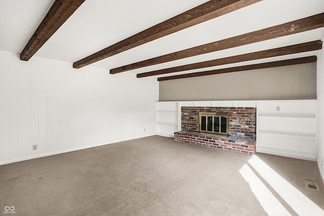 unfurnished living room with carpet floors, beam ceiling, and a brick fireplace