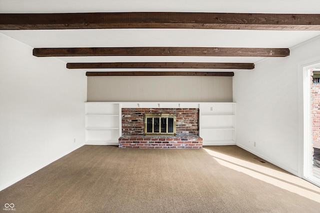 unfurnished living room featuring carpet flooring, beamed ceiling, and a brick fireplace