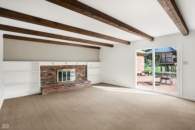 unfurnished living room with carpet, beam ceiling, and a brick fireplace