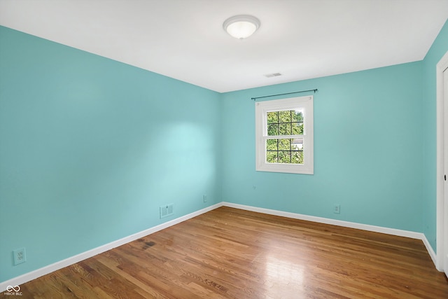 spare room featuring hardwood / wood-style flooring