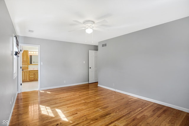 spare room featuring light wood-type flooring and ceiling fan