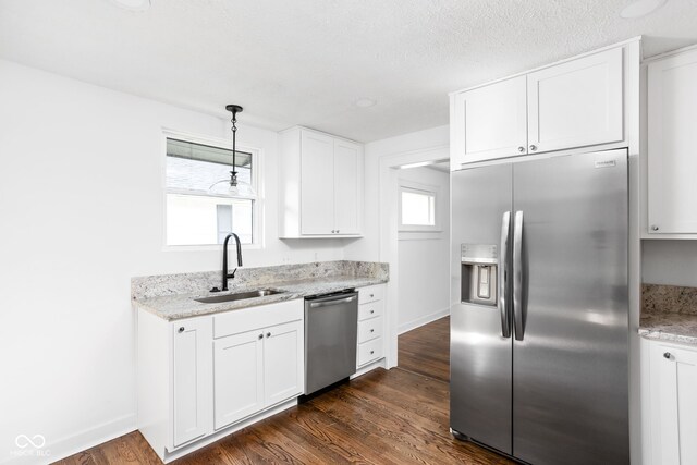 kitchen featuring white cabinets, a healthy amount of sunlight, stainless steel appliances, and sink