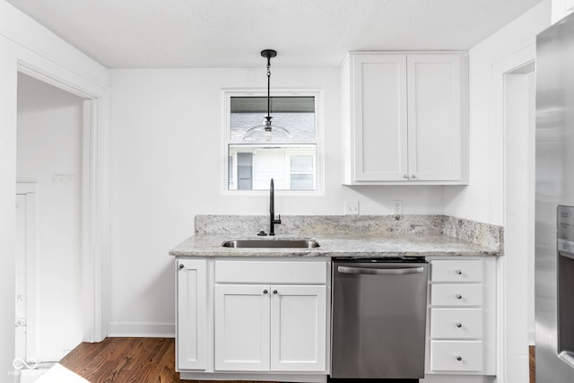 kitchen with sink, dishwasher, decorative light fixtures, and white cabinets