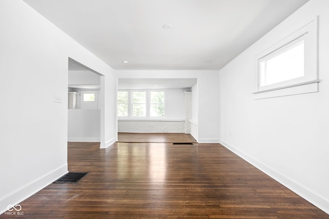 spare room featuring dark hardwood / wood-style flooring