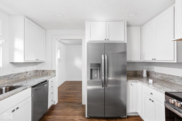 kitchen featuring white cabinetry, stainless steel appliances, and dark hardwood / wood-style floors