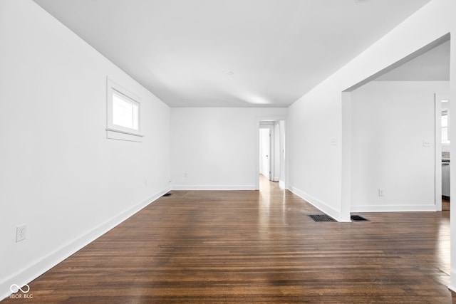 unfurnished room with dark hardwood / wood-style floors