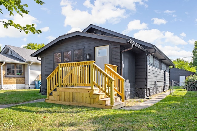 view of front of property with a front yard and fence