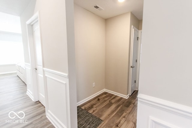 hall with hardwood / wood-style floors