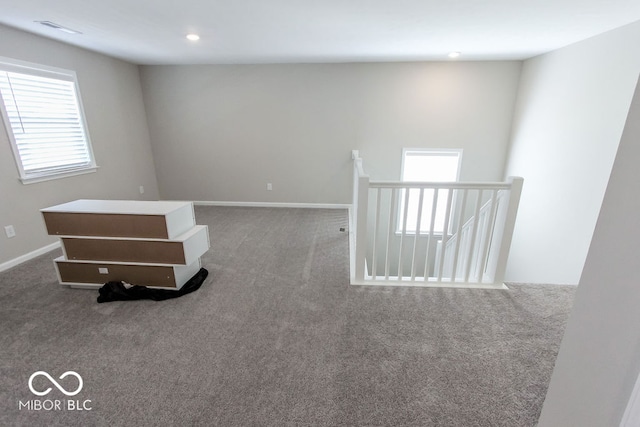 carpeted empty room featuring a wealth of natural light