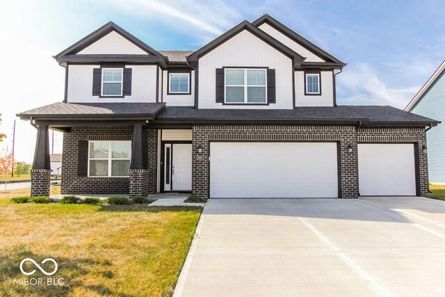 view of front of property featuring a garage and a front lawn