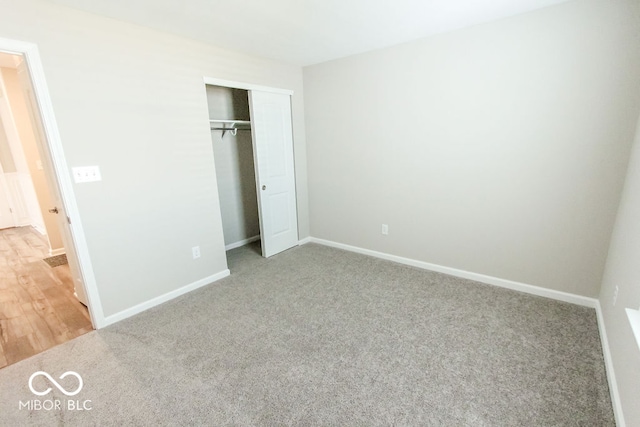 unfurnished bedroom featuring carpet floors and a closet