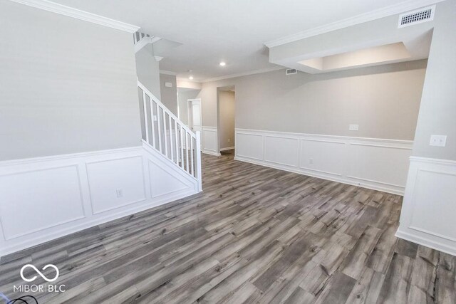 empty room featuring ornamental molding and dark hardwood / wood-style floors