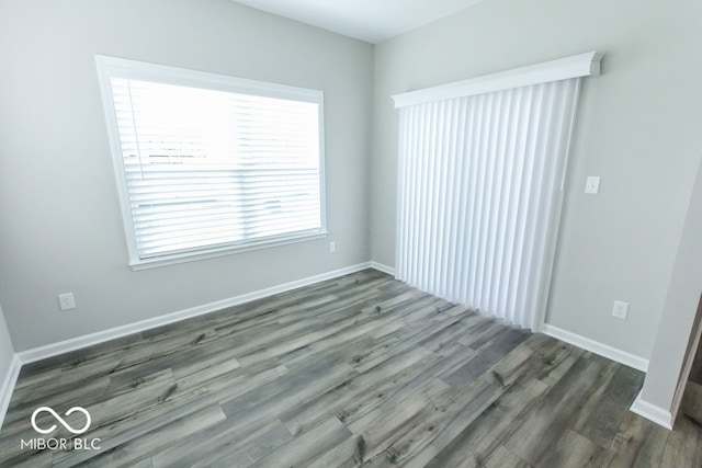 spare room with dark hardwood / wood-style flooring