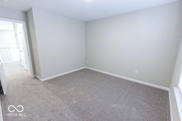 unfurnished room featuring light colored carpet