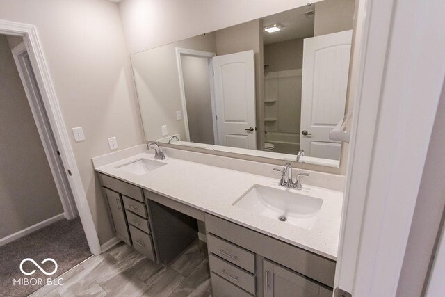 bathroom with vanity, hardwood / wood-style floors, and shower / bathing tub combination