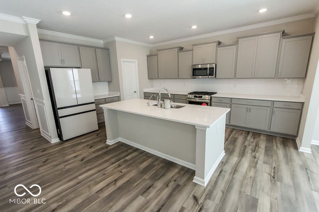 kitchen with gray cabinets, appliances with stainless steel finishes, wood-type flooring, and a kitchen island with sink