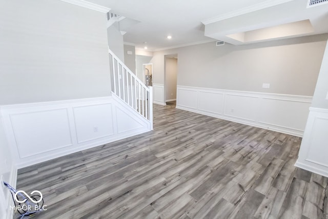 spare room with crown molding and wood-type flooring