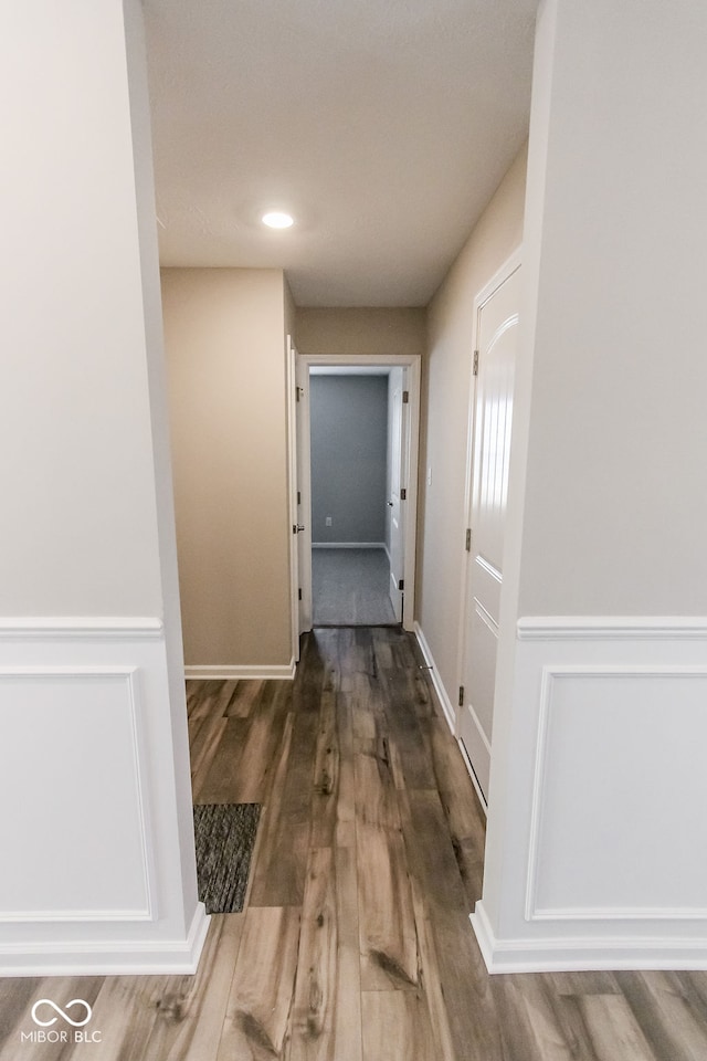 corridor with wood-type flooring