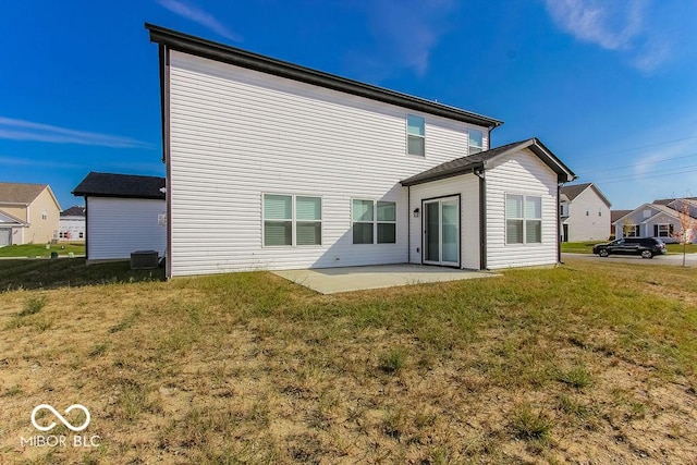 rear view of property featuring a yard and a patio