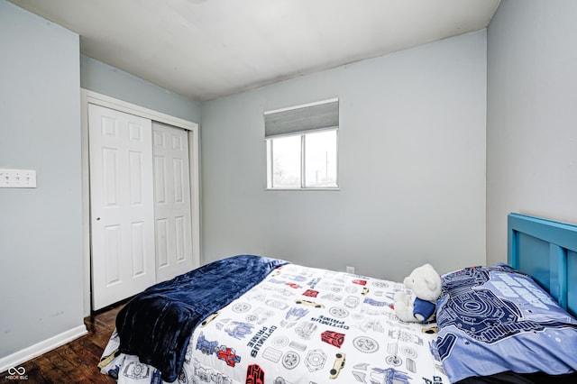 120 Hugo St, Indianapolis, IN 46229 - bedroom featuring a closet, baseboards, and wood finished floors
