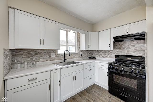 120 Hugo St, Indianapolis, IN 46229 - kitchen with a sink, decorative backsplash, black gas range, white cabinets, and under cabinet range hood