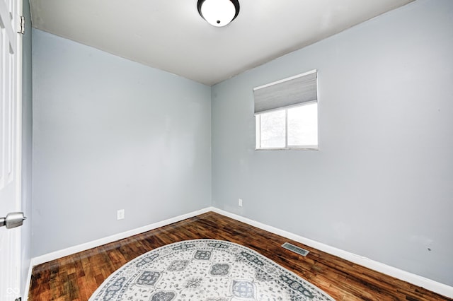 120 Hugo St, Indianapolis, IN 46229 - unfurnished room with dark wood-type flooring, baseboards, and visible vents