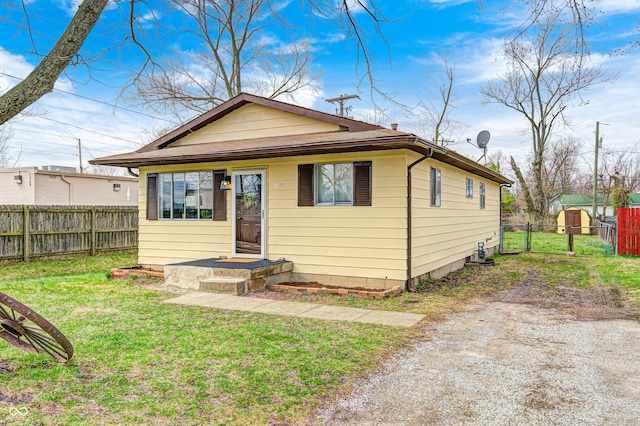 120 Hugo St, Indianapolis, IN 46229 - bungalow-style home with a gate, a front lawn, and fence