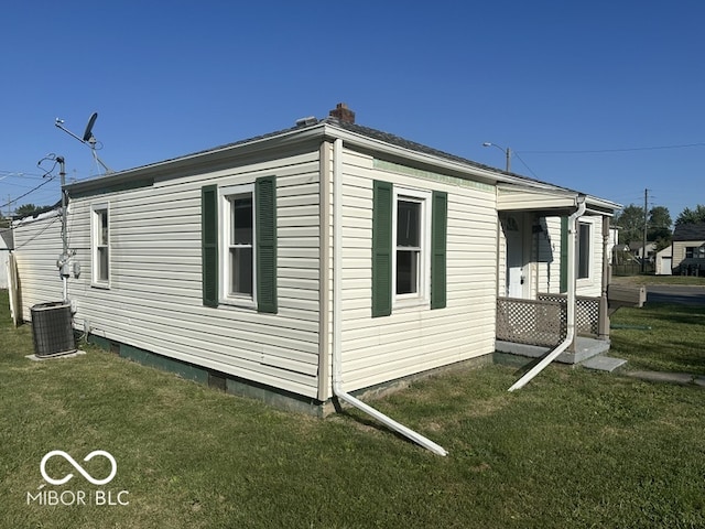 view of property exterior with a lawn and central air condition unit