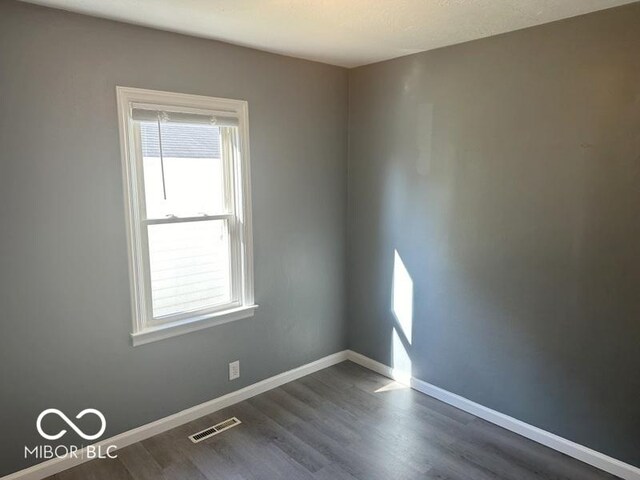 empty room with dark hardwood / wood-style floors