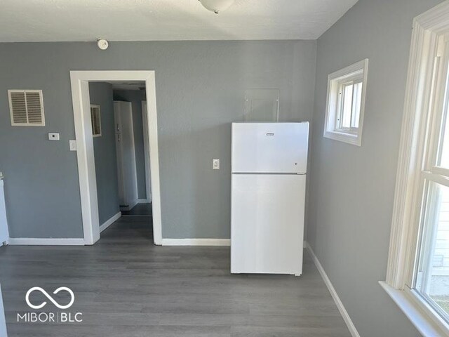 kitchen featuring white fridge and dark hardwood / wood-style floors