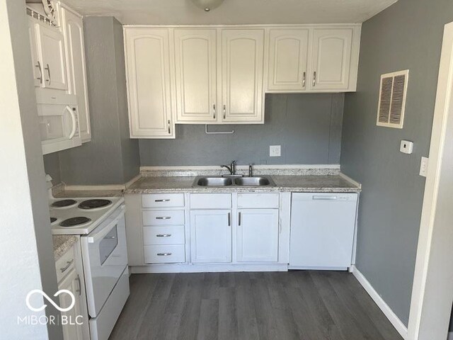 kitchen with sink, dark hardwood / wood-style floors, white appliances, and white cabinetry