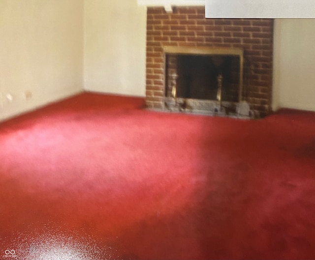 unfurnished living room with carpet floors and a fireplace