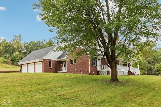 view of front of home with a garage and a front lawn