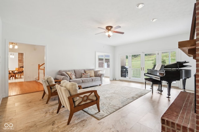 living room with light wood-type flooring and ceiling fan