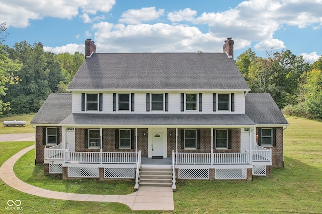 view of front facade featuring covered porch and a front yard