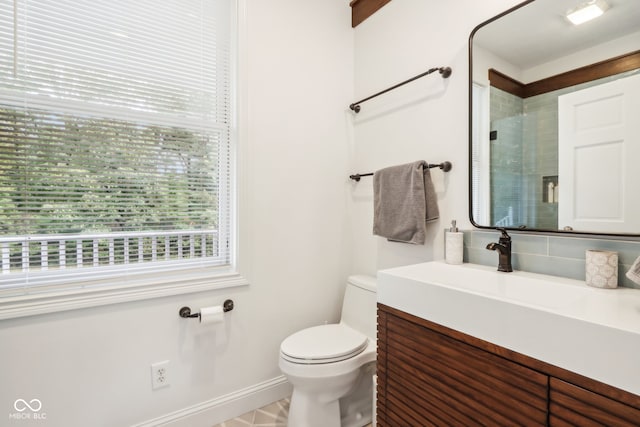 bathroom featuring a shower, vanity, and toilet