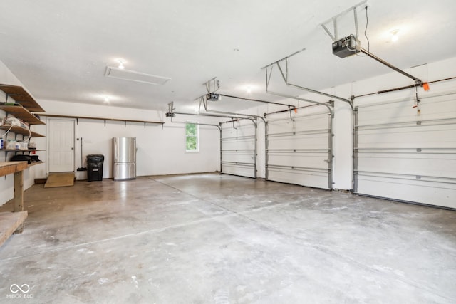 garage featuring a garage door opener and stainless steel fridge