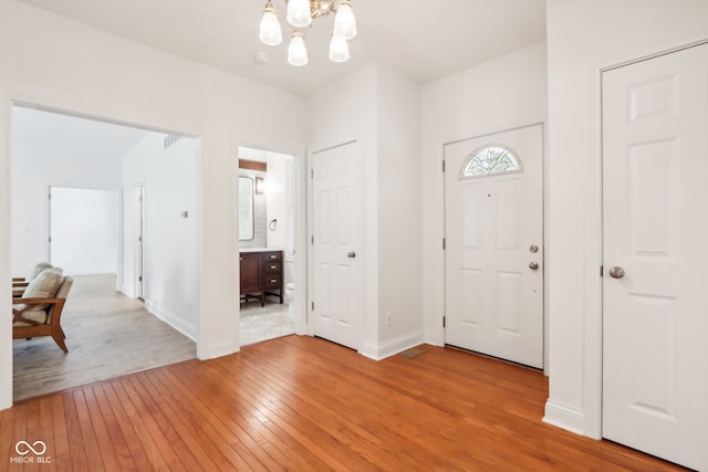 entrance foyer featuring a chandelier and hardwood / wood-style flooring