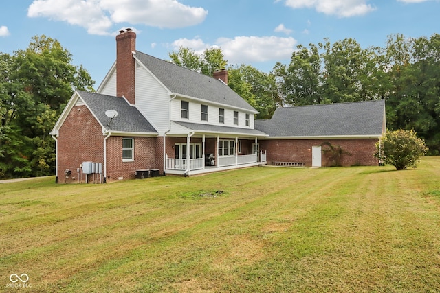 rear view of house featuring a yard