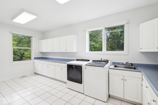 laundry room with cabinets, a wealth of natural light, washer and dryer, and sink