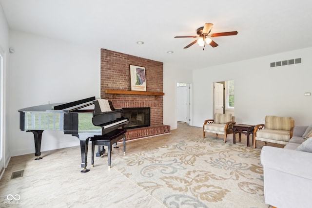 living room with a brick fireplace and ceiling fan