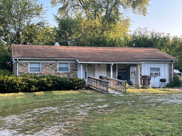 single story home featuring cooling unit and a front lawn