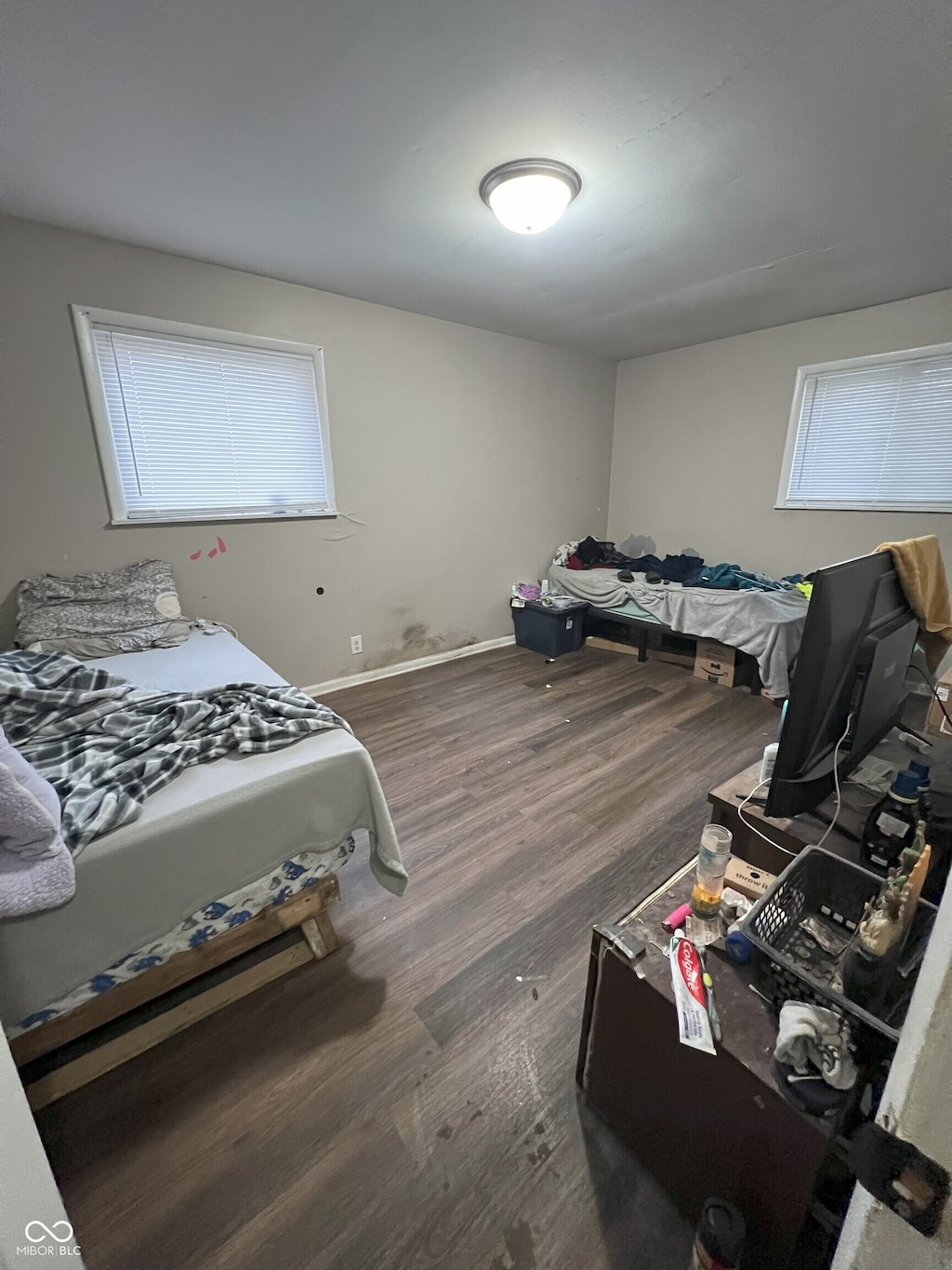 bedroom with dark hardwood / wood-style floors