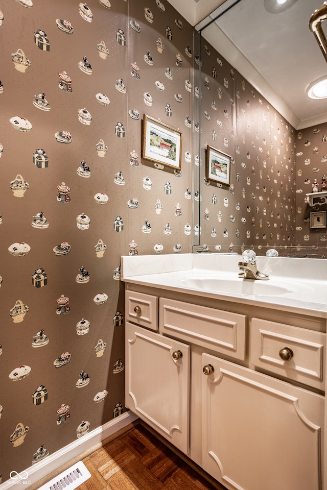 bathroom featuring parquet floors and vanity