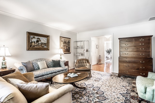 living room with light hardwood / wood-style floors and ornamental molding