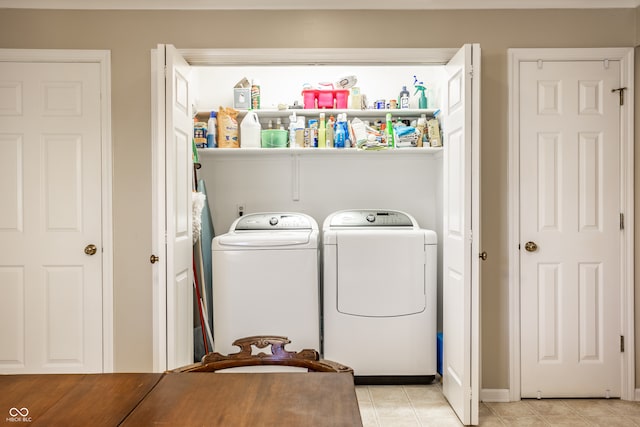 washroom with light tile patterned floors and washing machine and clothes dryer