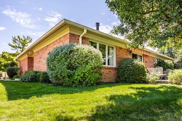 view of side of home featuring a yard