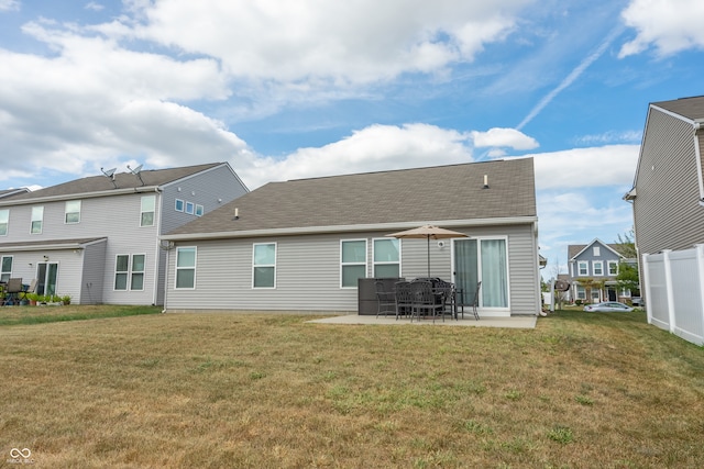 rear view of house featuring a patio and a yard