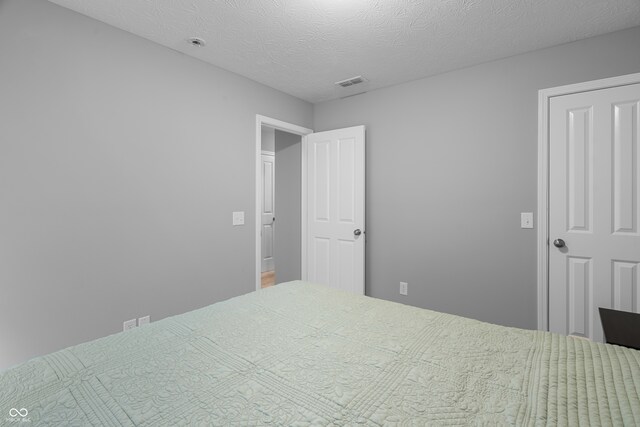 bedroom featuring a textured ceiling